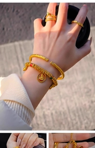 Detailed close-up of 24k gold plated zircon bracelet with traditional cloud patterns
