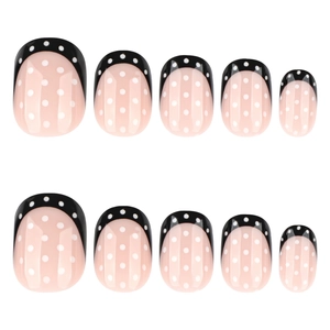 Minimalist French black tip press-on nails with white polka dots in a short square shape
