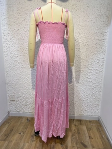 Detailed back view of pink maxi dress with elastic band and thin strap details