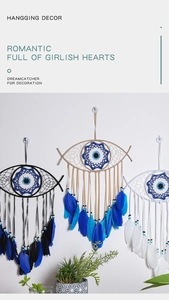 Detailed view of three woven evil eye dreamcatchers with feathers in bohemian style