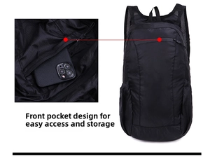 Detail of the front zipper pocket on a black lightweight waterproof folding backpack