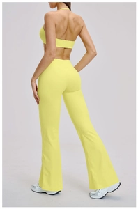 Detail view of the lemon yellow yoga set featuring a backless bra and flare leggings