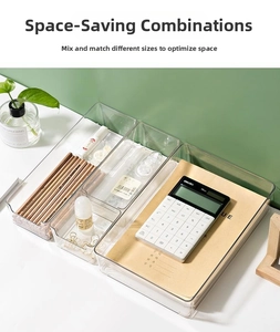 Close-up of clear modular drawer organizers in a stackable desktop storage layout