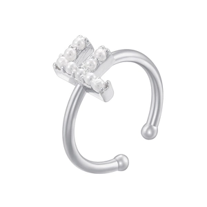 Detailed view of silver letter F ear cuff inlaid with small pearls on white background