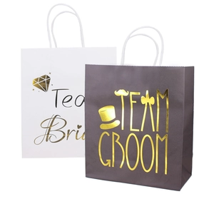 Detail of black and white wedding gift bags with Team Bride and Groom gold foil prints