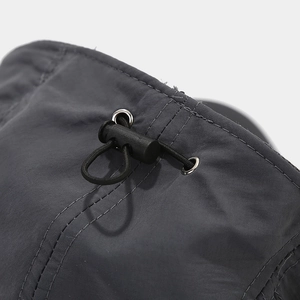 Detail of adjustable drawstring system with metal eyelets on dark grey outdoor cap