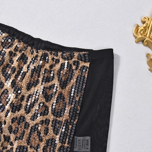 Macro shot of leopard print sequins and mesh fabric on fashion shorts for women