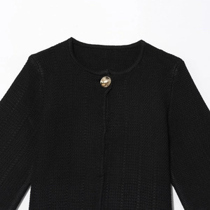 Chunky black knit cardigan with round neck and single decorative gold button detail