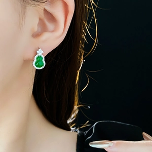 Close-up of elegant gourd-shaped green jade stud earrings with sparkling zircon borders