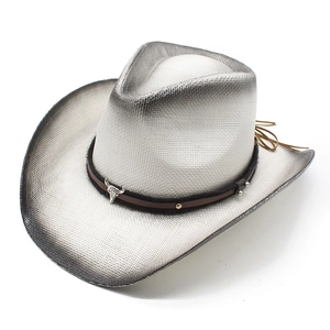 Detail of silver woven cowboy hat featuring a metal bull head emblem and leather straps