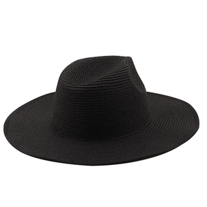 Close-up of black straw fedora hat featuring 9.5cm flat brim and detailed weave texture