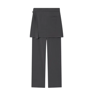 Detail of dark grey blazer fabric trousers with integrated skirt overlay and belted waist