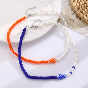 Detailed shot of handmade colorful beaded necklaces featuring ceramic fish pendants