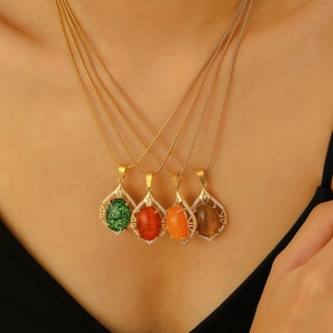 Macro view of baroque stainless steel necklaces with colorful oval gemstone pendants