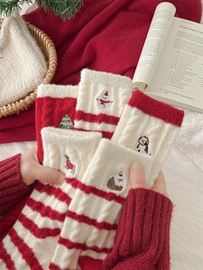 Detailed close-up of festive red and white striped Christmas socks with snowman embroidery
