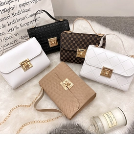 Detail showing five assorted printed square bags with golden locks and chain straps