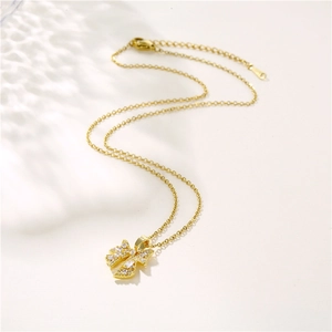 Elegant gold bow necklace for women with sparkling zircons and a classic O-chain