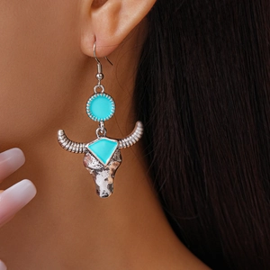 Bohemian bull head earrings with turquoise enamel and vintage silver finish on model