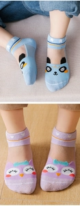 Detail of mesh socks for kids featuring panda and owl cartoon designs in blue and purple