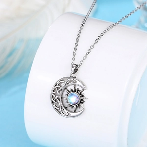Detailed view of Celtic sun and moon necklace pendant with glowing moonstone inlay