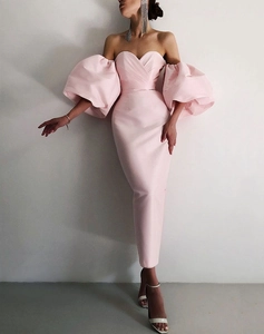 Close-up of pink off-the-shoulder puff sleeves on a satin evening gown for women