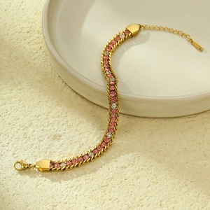 Detail of gold stainless steel bracelet with pink and white crystal zircon inlay