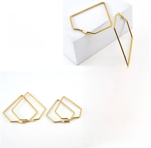 Detailed view of large geometric hoop earrings with polished gold plating and fine texture