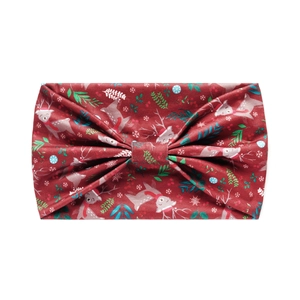 Detailed pattern of red Christmas headband featuring festive reindeer and snowflake prints
