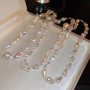 Macro view of irregular baroque pearls with iridescent aurora luster in a jewelry box