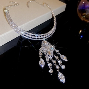 Detail view of silver luxury choker with sparkling crystals and elegant pearl fringe tassels