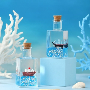 Creative fluid drift bottle desk decor with miniature sailboat and blue liquid inside