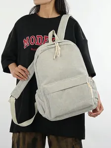 Light gray corduroy backpack for students with large front pocket and side water bottle slot