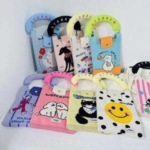 Flat lay of diverse knitted cat and cartoon mini handbags with thick padded handles