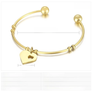 Detail of gold stainless steel open cuff bracelet with hollow heart pendant charms
