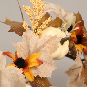 Autumn wreath with faux maple leaves, cream pumpkins and sunflowers for harvest decor