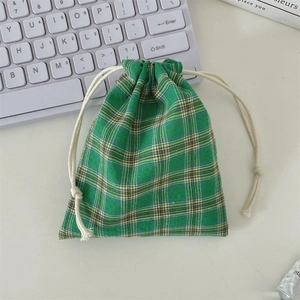 Detail of checkered drawstring storage bag with cotton cord and soft fabric texture