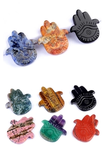 Multiple carved natural stone Hamsa hands in various colors like amethyst and jade