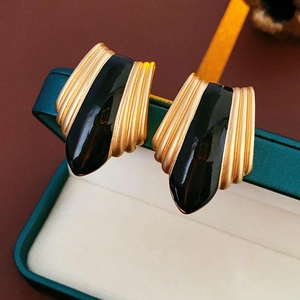 Detail of vintage French black and gold teardrop earrings in a teal jewelry gift box