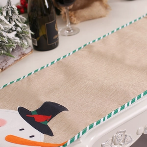 Christmas burlap table runner featuring snowman applique and green striped edging