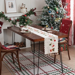 Christmas table runner with lace bells, embroidery and tassels on wooden table