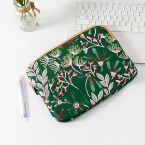 Detailed view of quilted green floral laptop sleeve with daisies and metal zipper