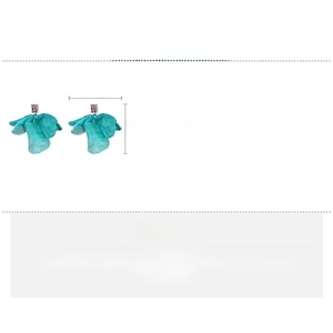 Detail view of teal mesh flower earrings featuring cubic zirconia and copper studs