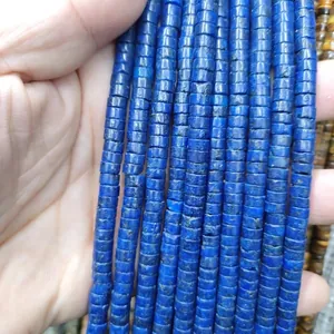 Macro view of blue cylindrical natural stone spacer beads with matte mineral texture