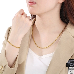 Dettaglio del set collana e bracciale in acciaio inossidabile dorato a maglia intrecciata
