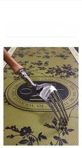 Detail of waterproof green faux leather placemat showing scratch-resistant texture surface