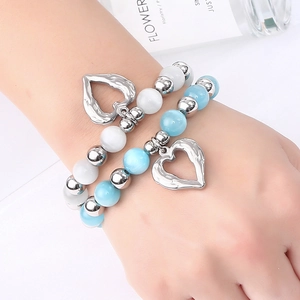 Double-layered beaded bracelet with blue cat's eye stones and heart pendants