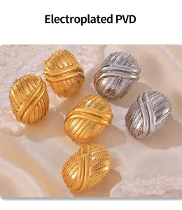 Macro detail of multi-layered PVD plated gold and silver geometric titanium earrings