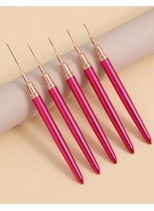 Detail of 5-piece magenta nail art liner brushes with fine tips on a beige pedestal