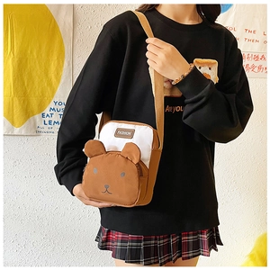 Close-up of cute bear-shaped crossbody bag featuring 3D ears and contrast color design
