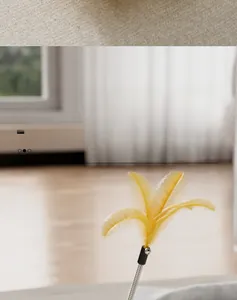 Detail of the tumbler cat toy showing the yellow feather and spring rod on the base